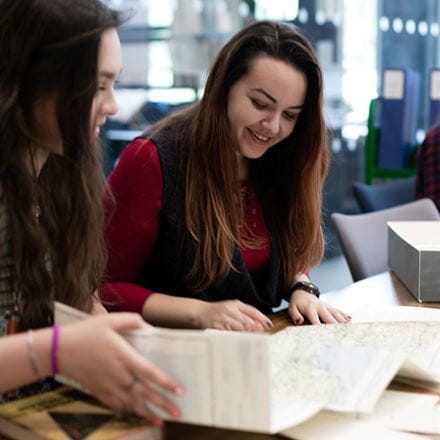 Two people looking at a folded map